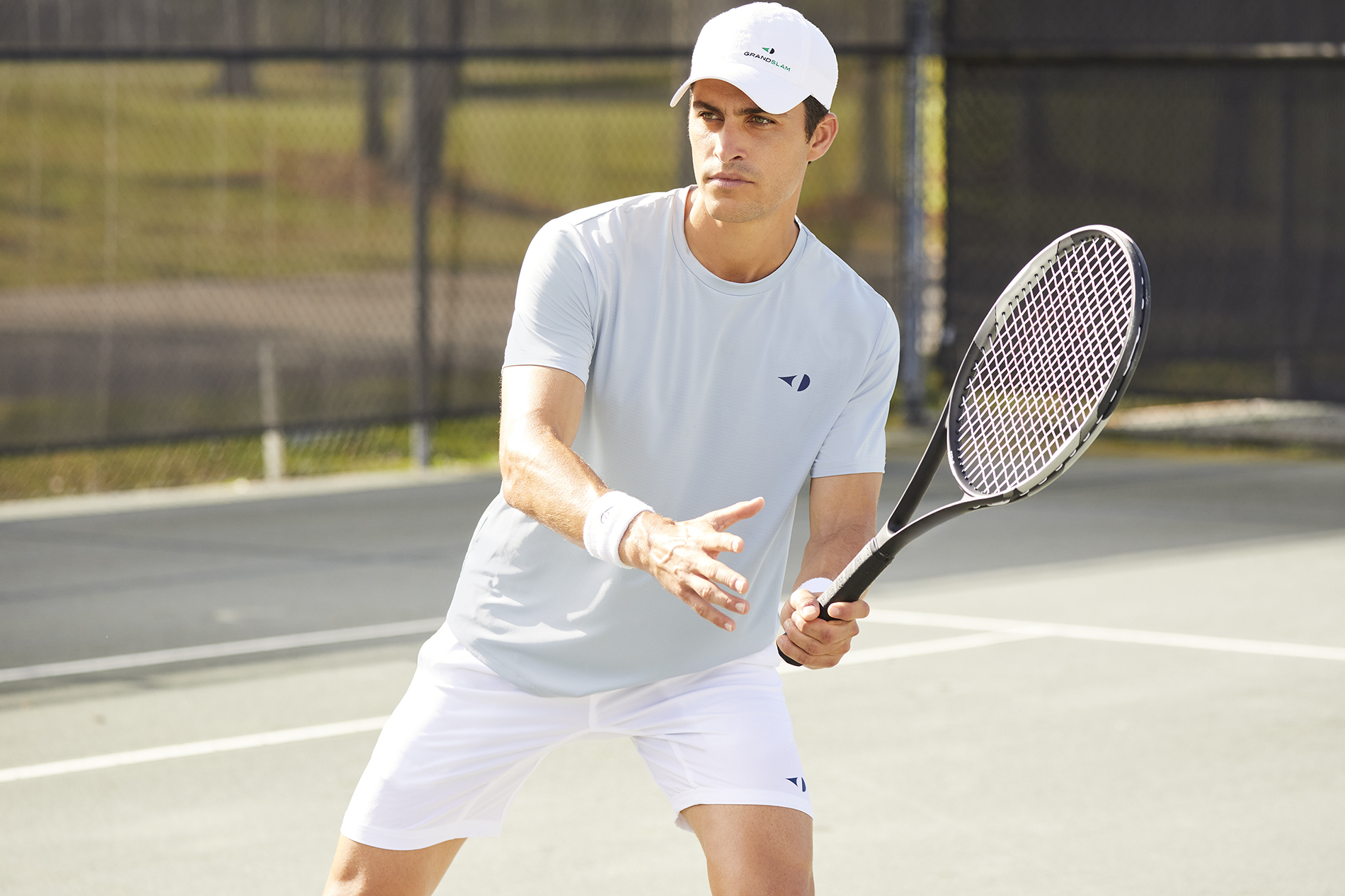 Player wearing a Grand Slam polo shirt.